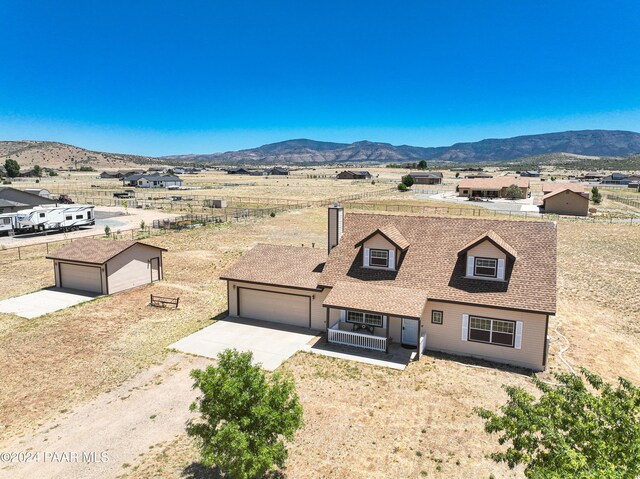 view of front of house with a mountain view, covered porch, and a garage