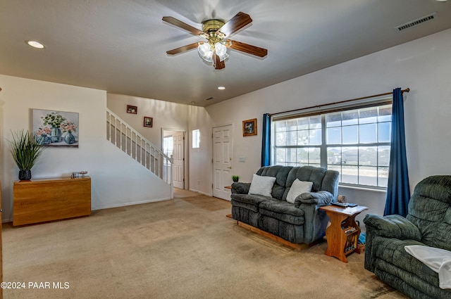 carpeted living room featuring ceiling fan