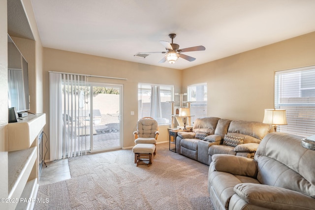 living room featuring light carpet and a ceiling fan