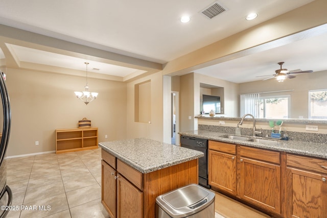 kitchen with visible vents, brown cabinetry, a sink, a kitchen island, and dishwasher