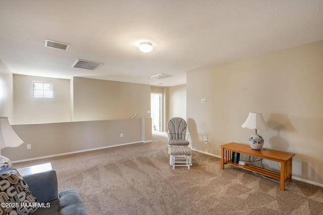 sitting room with baseboards, visible vents, and carpet flooring