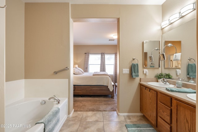 ensuite bathroom featuring tile patterned floors, visible vents, connected bathroom, a sink, and a bath