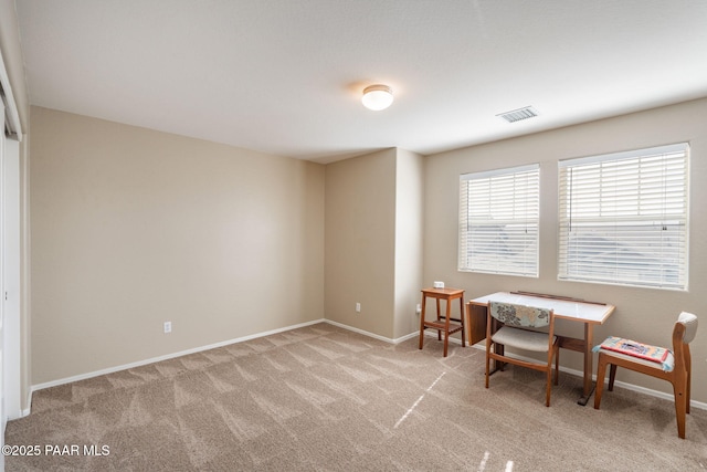 sitting room featuring baseboards, visible vents, and light colored carpet