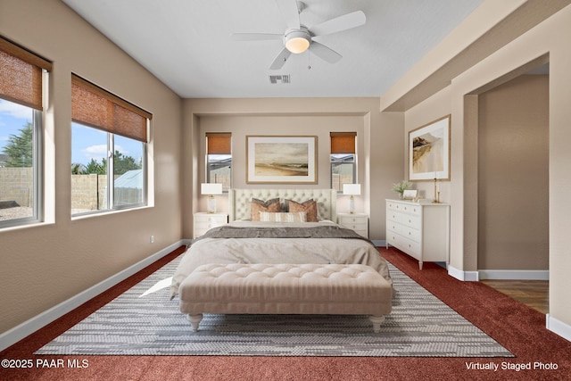 bedroom with a ceiling fan, baseboards, and visible vents