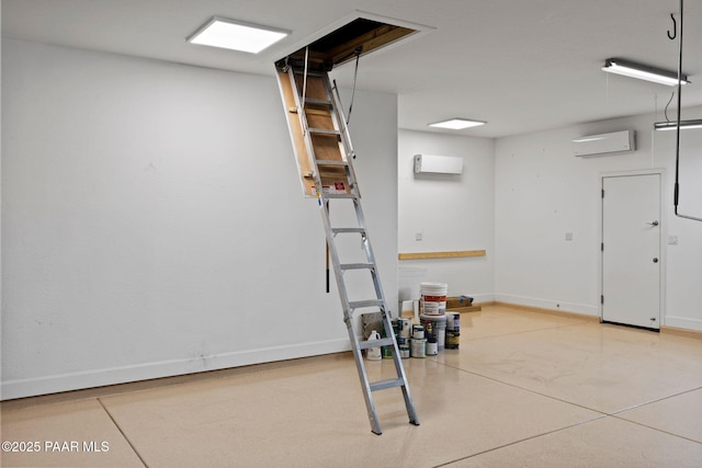 basement featuring baseboards and a wall mounted AC