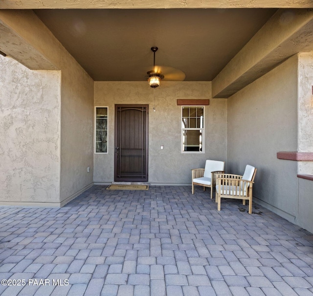 property entrance featuring stucco siding and a patio