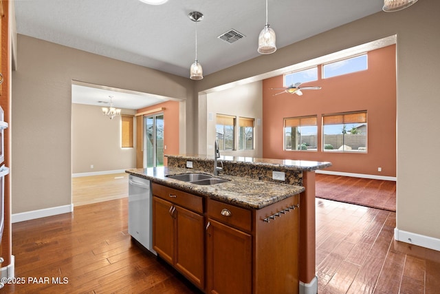 kitchen with a sink, wood-type flooring, dishwasher, and open floor plan