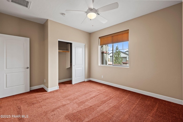 unfurnished bedroom with a ceiling fan, baseboards, visible vents, carpet floors, and a closet