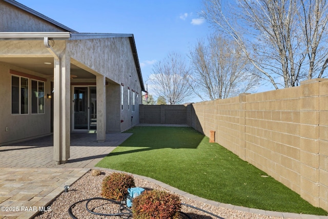 view of yard with a fenced backyard and a patio area