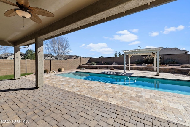 view of pool with ceiling fan, a patio area, a fenced backyard, and a pergola