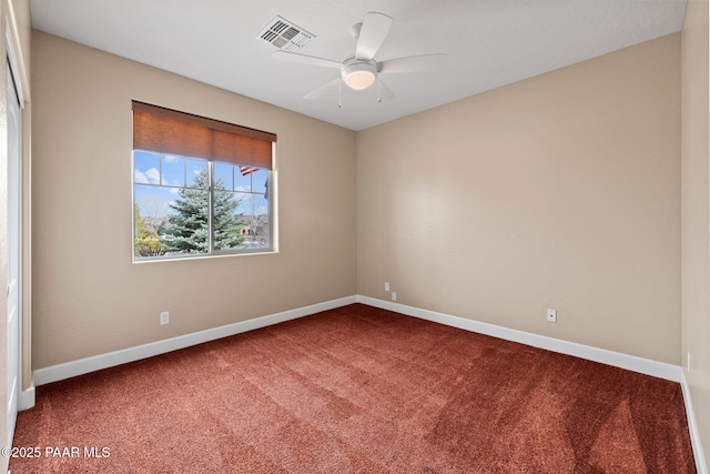 empty room with visible vents, carpet flooring, a ceiling fan, and baseboards