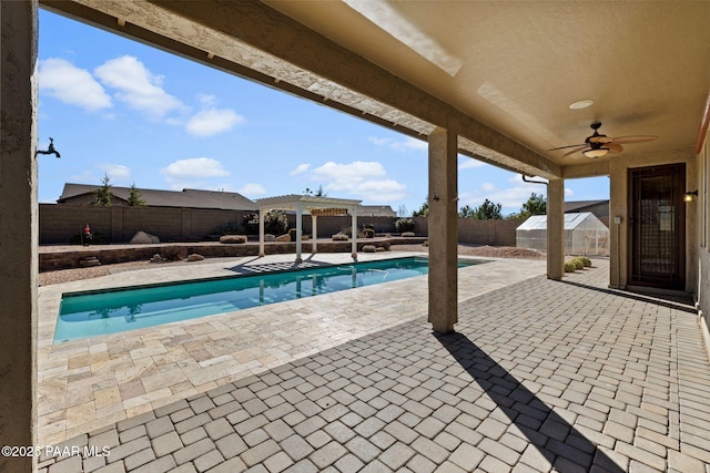 view of pool featuring a ceiling fan, a fenced in pool, a fenced backyard, a pergola, and a patio area