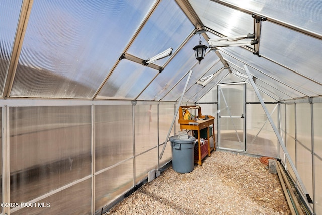 unfurnished sunroom featuring lofted ceiling