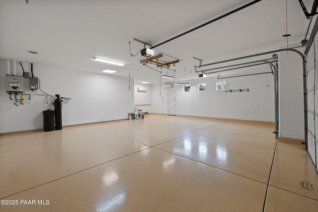 garage featuring a garage door opener and baseboards