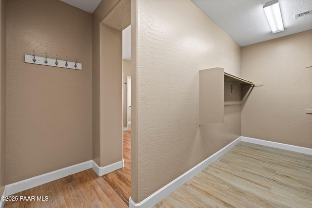 interior space with visible vents and wood finished floors