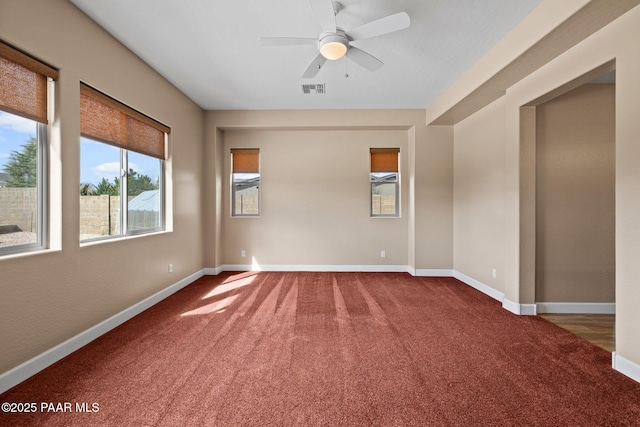 unfurnished room featuring visible vents, baseboards, carpet floors, and a ceiling fan