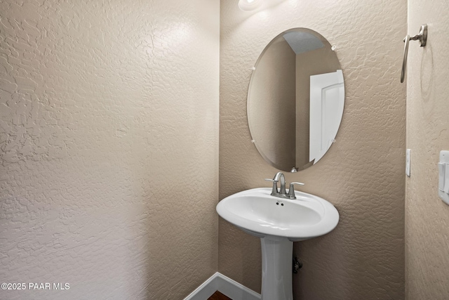 bathroom with a textured wall