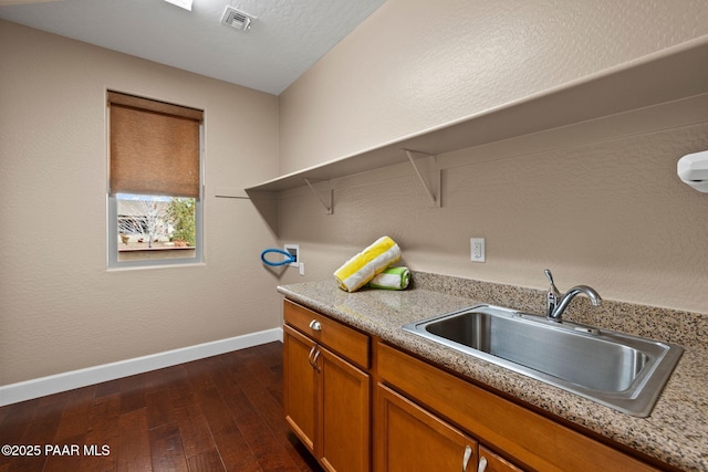 kitchen with visible vents, a sink, light countertops, brown cabinets, and open shelves