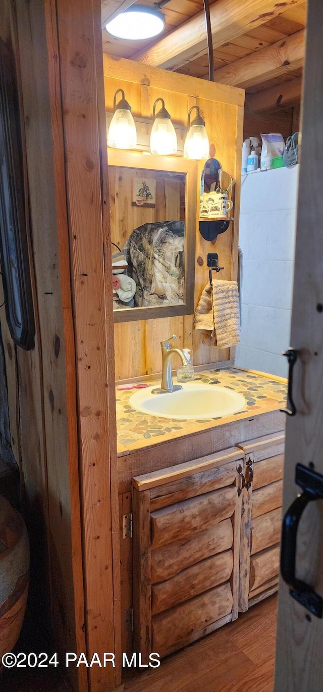 bathroom with vanity, hardwood / wood-style flooring, and wood ceiling