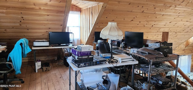 office with wooden walls and hardwood / wood-style floors