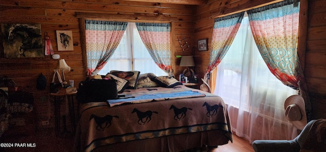 bedroom featuring wooden walls and hardwood / wood-style flooring