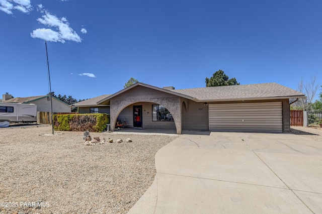 single story home featuring a garage, fence, and driveway