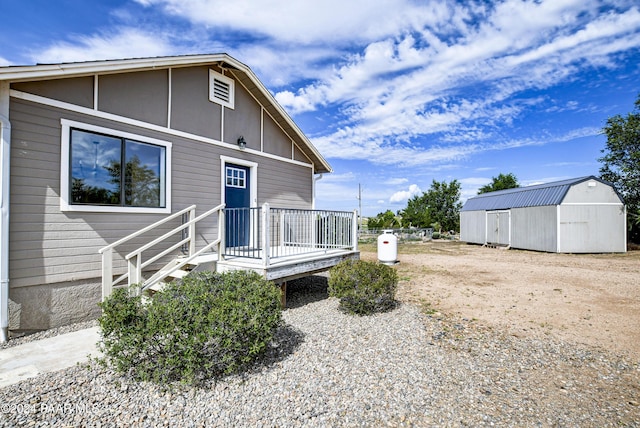 view of front of home featuring a storage shed and a wooden deck