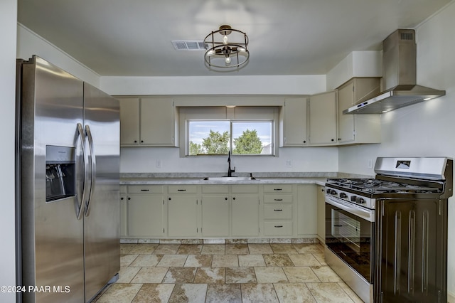 kitchen with sink, wall chimney exhaust hood, a chandelier, and appliances with stainless steel finishes