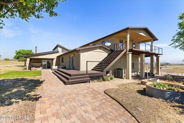 1445 S Table Mountain Rd, Chino Valley, AZ 86323 - back of house featuring stucco siding, a patio, cooling unit, and a wooden deck