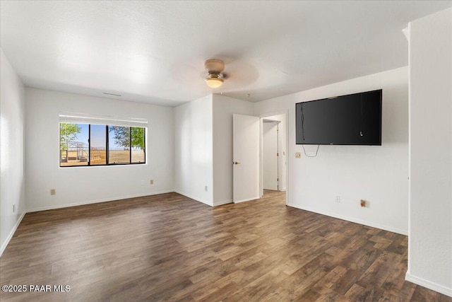 1445 S Table Mountain Rd, Chino Valley, AZ 86323 - unfurnished living room featuring wood finished floors, a ceiling fan, and baseboards