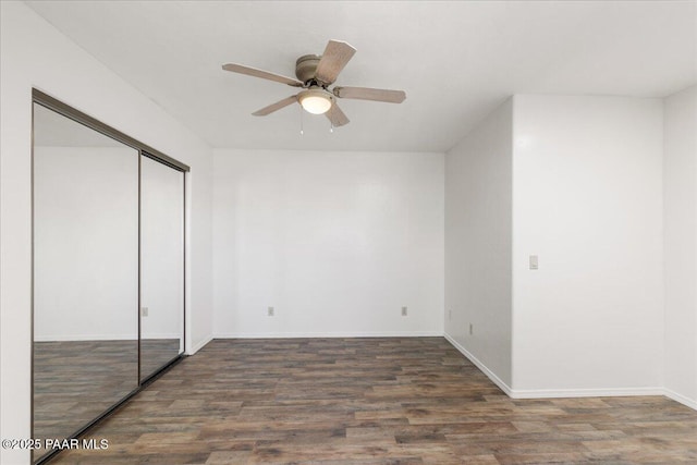 1445 S Table Mountain Rd, Chino Valley, AZ 86323 - unfurnished bedroom with wood finished floors, a closet, baseboards, and a ceiling fan