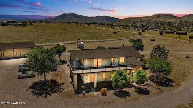 1445 S Table Mountain Rd, Chino Valley, AZ 86323 - view of front facade featuring a balcony, a mountain view, stucco siding, and a rural view