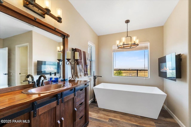 1445 S Table Mountain Rd, Chino Valley, AZ 86323 - full bath with a freestanding bath, healthy amount of natural light, vanity, and wood finished floors