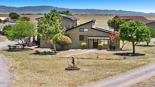 1445 S Table Mountain Rd, Chino Valley, AZ 86323 - view of front of home featuring solar panels, stucco siding, and a mountain view