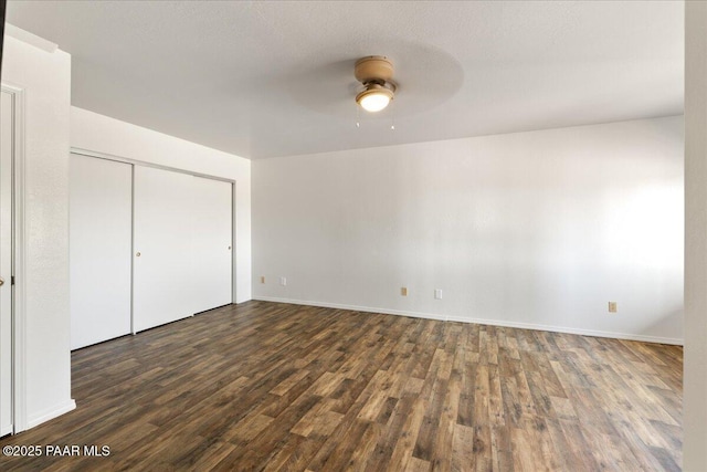 1445 S Table Mountain Rd, Chino Valley, AZ 86323 - unfurnished bedroom featuring wood finished floors, a closet, baseboards, and ceiling fan