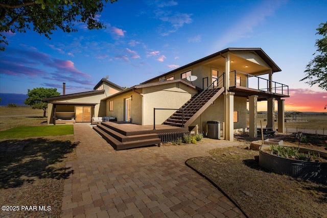 1445 S Table Mountain Rd, Chino Valley, AZ 86323 - back of property featuring stucco siding, a patio area, a wooden deck, and central AC