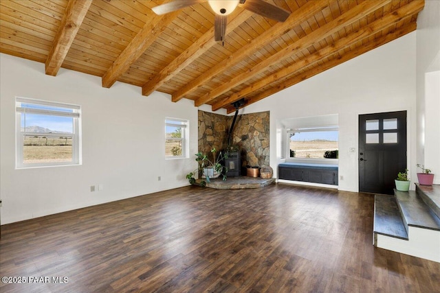 1445 S Table Mountain Rd, Chino Valley, AZ 86323 - unfurnished living room with wooden ceiling with exposed beams, a wood stove, wood finished floors, a ceiling fan, and high vaulted ceiling