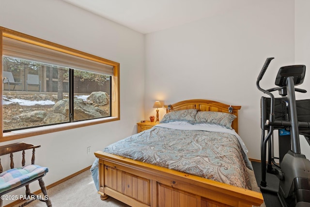 bedroom featuring light colored carpet and baseboards