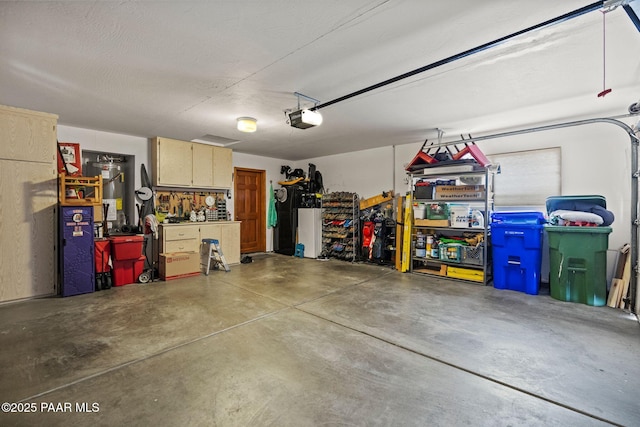 garage with a workshop area and a garage door opener