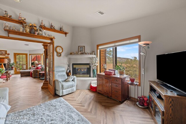 living room with plenty of natural light, a fireplace, and visible vents