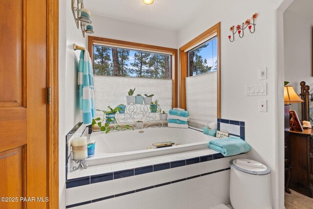 full bath with a healthy amount of sunlight and a garden tub