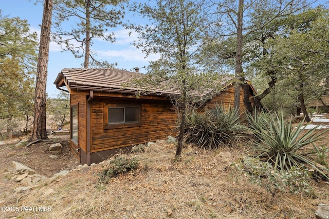 view of side of home featuring a tile roof