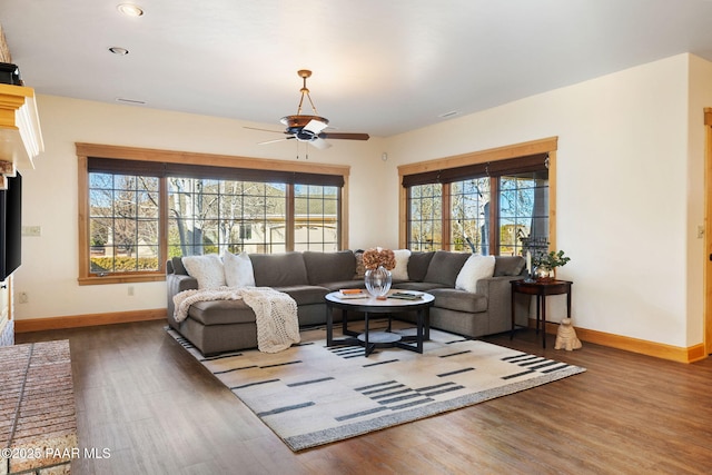 living room with hardwood / wood-style floors and ceiling fan