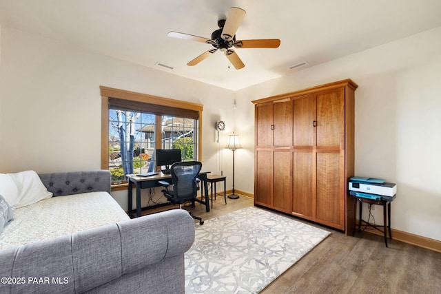 living room featuring light wood-type flooring and ceiling fan