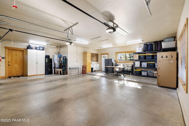 garage with gas water heater and a garage door opener