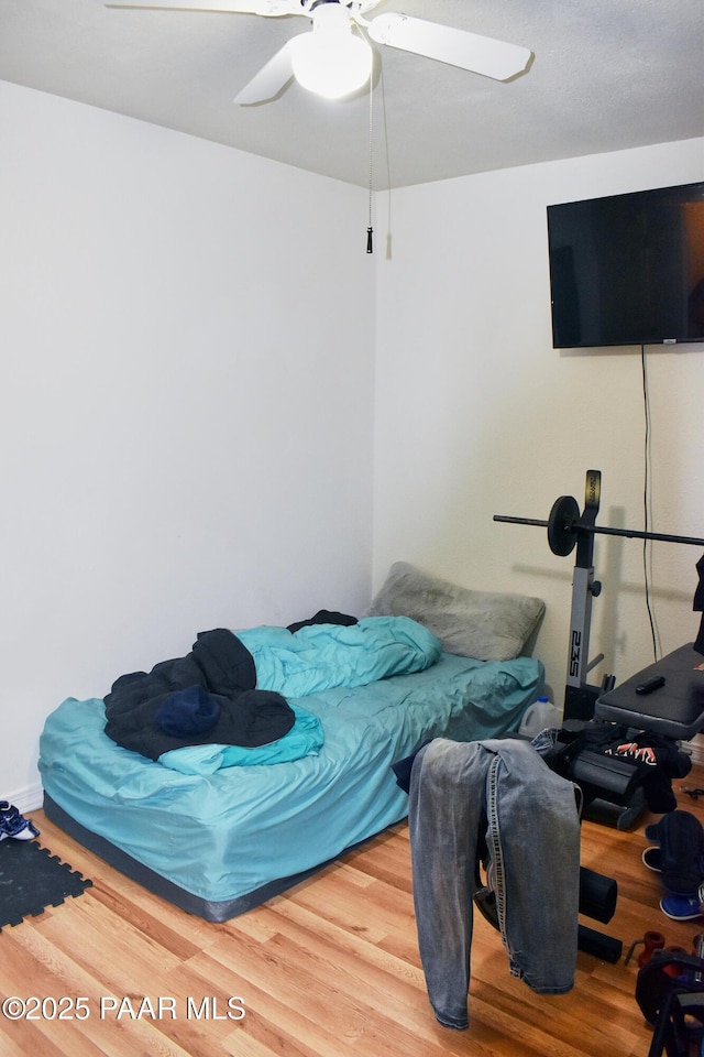 bedroom featuring wood finished floors and a ceiling fan