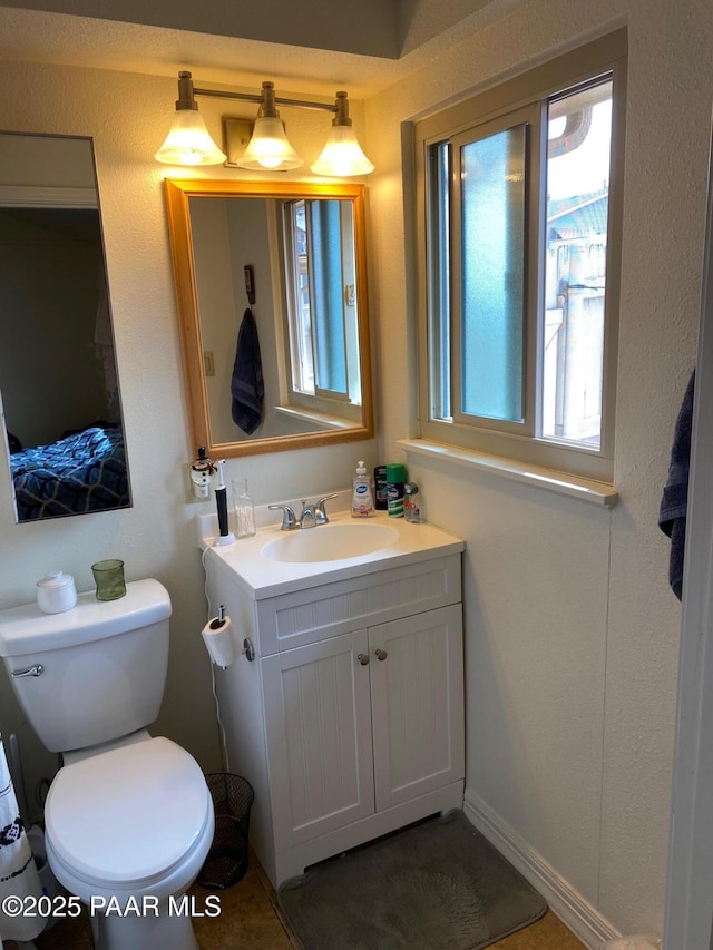 bathroom with toilet and vanity