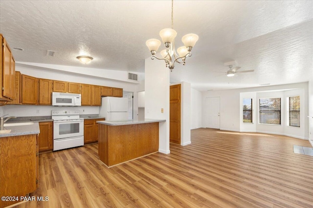 kitchen featuring white appliances, a textured ceiling, pendant lighting, light hardwood / wood-style flooring, and lofted ceiling