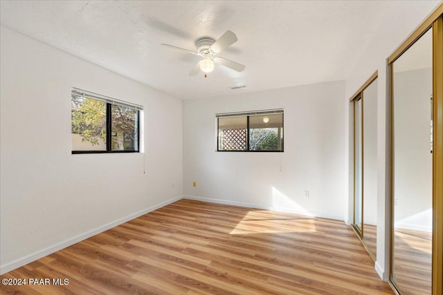 unfurnished bedroom featuring ceiling fan and light wood-type flooring