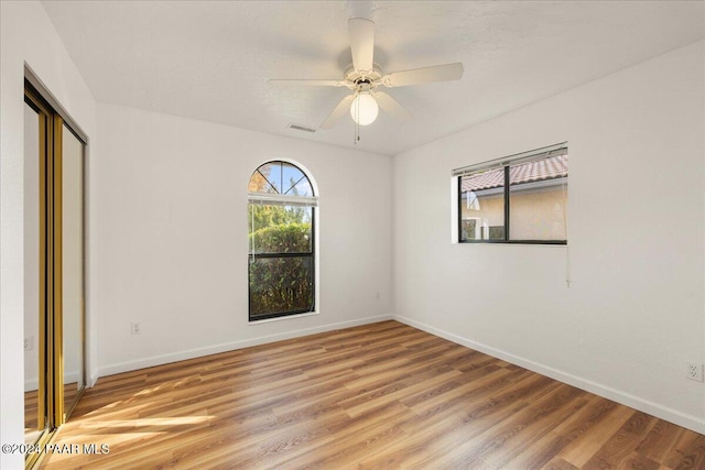 unfurnished bedroom with hardwood / wood-style floors and ceiling fan